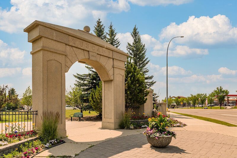 The Tuscany entrance arch with flower planters